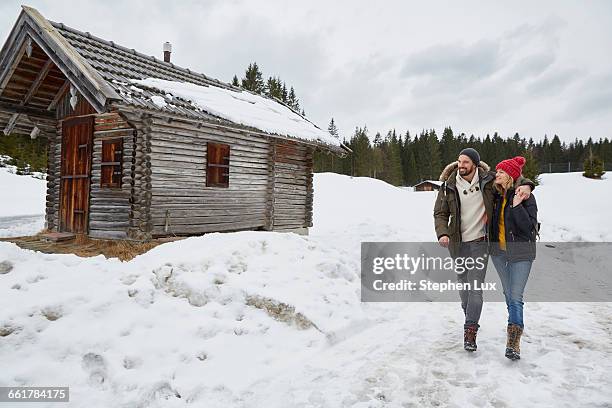 couple hiking from log cabin in winter, elmau, bavaria, germany - traditional parka stock pictures, royalty-free photos & images