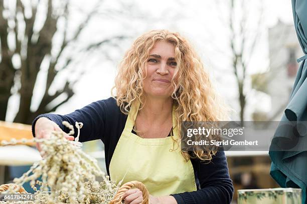 market trader with basket of olive branch - frizzy hair stock pictures, royalty-free photos & images