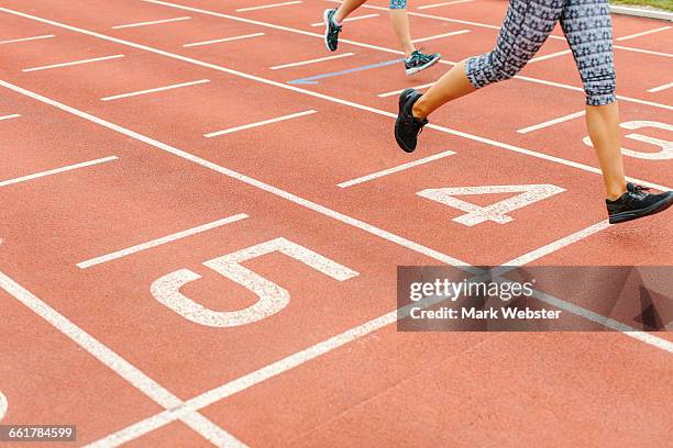 two young women running on running track, low section - live at leeds 2016 stock pictures, royalty-free photos & images