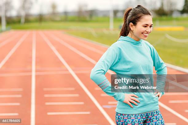 portrait of young girl on running track, smiling - live at leeds 2016 stock pictures, royalty-free photos & images