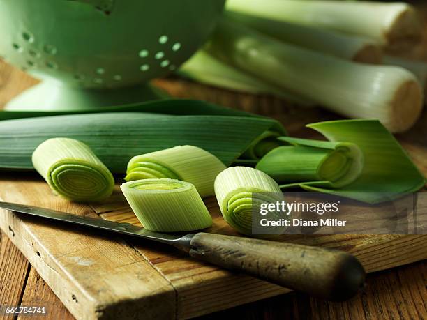 sliced leeks on chopping board, close-up - leek stock pictures, royalty-free photos & images