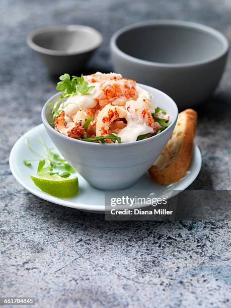 crayfish cocktail with rocket, lime wedge and crusty baguette slice - crayfish stock pictures, royalty-free photos & images