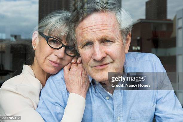 couple looking through window - husband stock-fotos und bilder