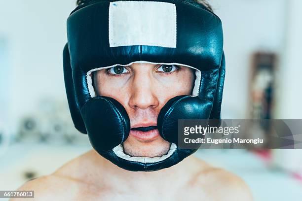 portrait of man wearing head protector looking at camera - headwear ストックフォトと画像