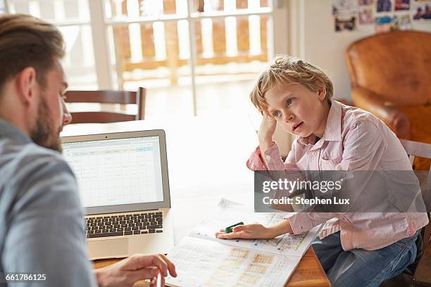 father helping son with homework in home office - boy asking stock pictures, royalty-free photos & images