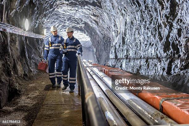 workers in tunnel in hydroelectric power station - hydroelectric power station stock pictures, royalty-free photos & images
