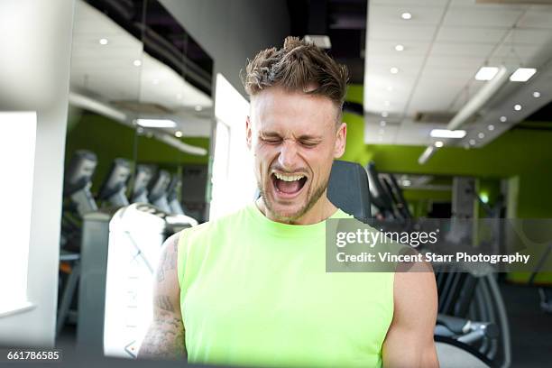 man at gym exercising, straining, pulling face - adrenaline stress stock pictures, royalty-free photos & images