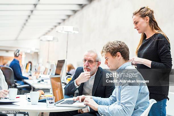 concentrated business people preparing project on laptop in office - senior men serious stock pictures, royalty-free photos & images