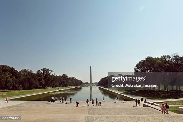 tourists at lincoln memorial park against clear blue sky - reflecting pool stock pictures, royalty-free photos & images