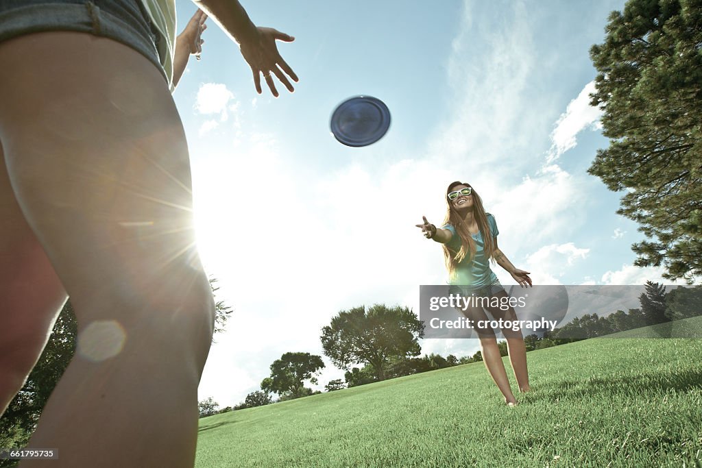 Two women playing game of Frisbee in park