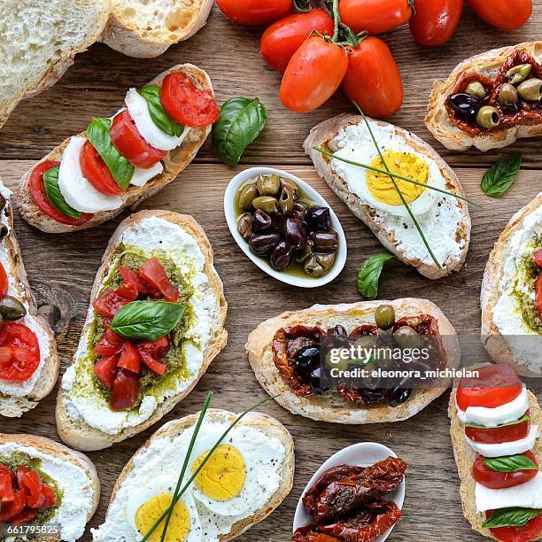 overhead view of bruschetta selection - bruschetta stock pictures, royalty-free photos & images