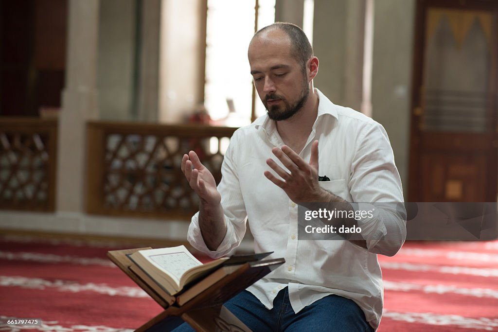 Man sitting in mosque praying