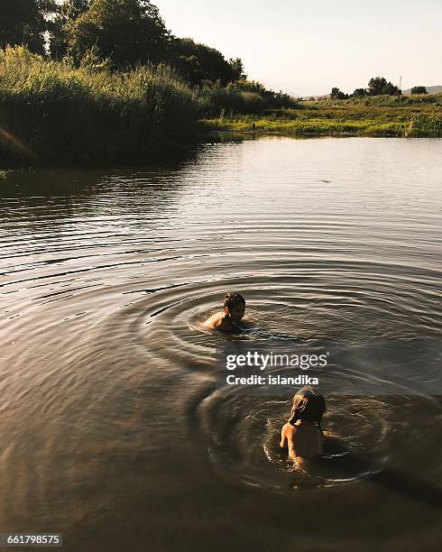 boy and girl swimming in river - taken on mobile device stock pictures, royalty-free photos & images