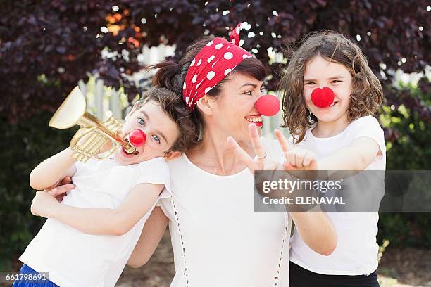 mother, son and daughter dressed as clowns - clowns nose stock pictures, royalty-free photos & images