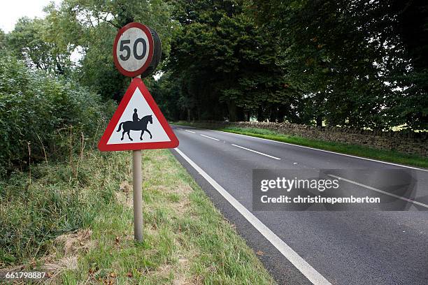 speed and horse crossing signs on road, cotswolds, gloucestershire, england, uk - speed limit sign stock pictures, royalty-free photos & images