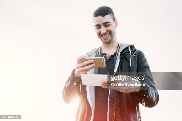 adult man depositing check with smart phone - cheque deposit stock pictures, royalty-free photos & images