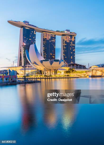 singapore city, singapore - 3rd february 2017: singapore city skyline showing the marina bay sands hotel with reflection in the still water at twilight - singapore stock pictures, royalty-free photos & images