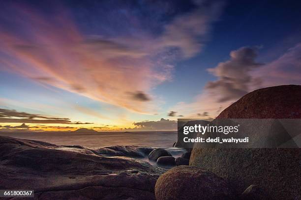 sunset over tanjung bajau beach, singkawang, indonesia - bajau stockfoto's en -beelden