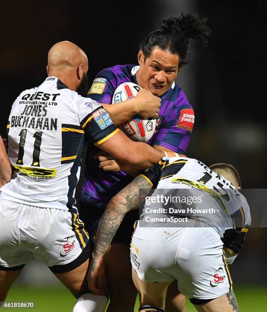 Wigan Warriors' Taulima Tautai is tackled by Leeds Rhinos's Jamie Jones Buchanan and Brett Delaney during the Betfred Super League Round 7 match...