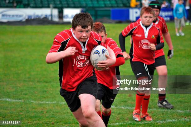 Young boys playing in a rugby tournament at Bath, England, UK.