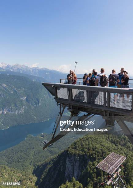 Triglav National Park, Upper Carniola, Slovenia, Visitors on the observation deck at the Vogel Ski Centre taking photographs, Lake Bohinj below.