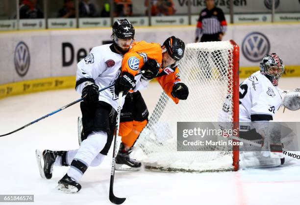 Sebastian Furchner of Wolfsburg and Jesse Blacker of Nuernberg battle for the puck during the DEL Playoffs semi finals Game 4 between Grizzlys...