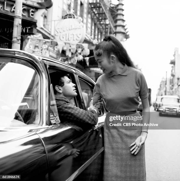 Mark Damon portrays Rod Campbell and Neva Aki portrays Patty Yung in the CBS television police drama program, "The Lineup" episode titled 'The...