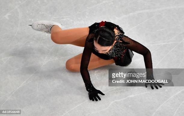 The US' Karen Chen falls during the woman's Free Skating event at the ISU World Figure Skating Championships in Helsinki, Finland on March 31, 2017....
