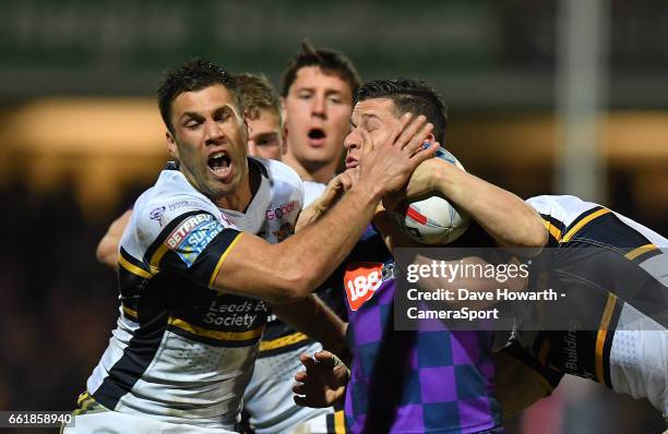 Wigan Warriors' Morgan Escare is tackled by Leeds Rhinos's Joel Moon during the Betfred Super League Round 7 match between Leeds Rhinos and Wigan...