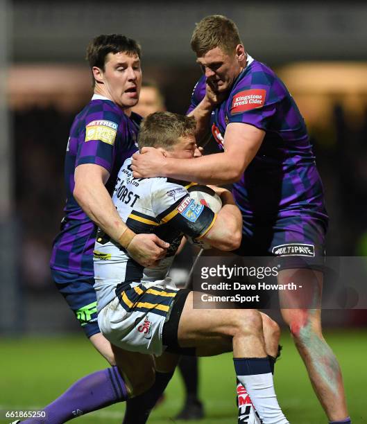 Leeds Rhinos's Jimmy Keinhorst is tackled by Wigan Warriors' Joel Tomkins and Ryan Sutton during the Betfred Super League Round 7 match between Leeds...