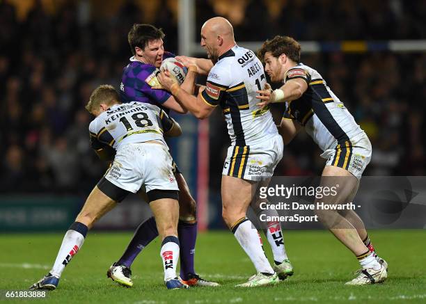 Wigan Warriors' Joel Tomkins is tackled by Leeds Rhinos's Jimmy Keinhorst and Carl Ablett during the Betfred Super League Round 7 match between Leeds...