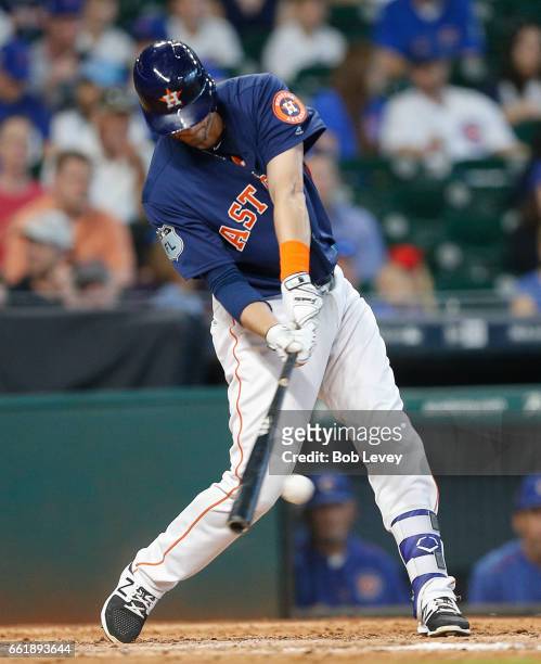 Reid Brignac of the Houston Astros singles in the sixth inning against the Chicago Cubs during an exhibition game at Minute Maid Park on March 31,...