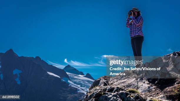 Photographer shooting pictures near Portage Glacier, Alaska.