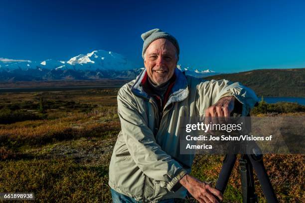 Photographer poses at famous Ansel Adams picture spot, Wonder Lake, Mount Denali, Kantishna, Alaska.