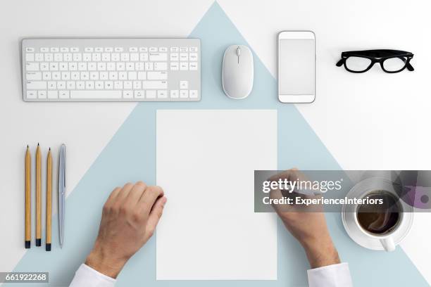 knolling hands writing on a blank paper - stationary desk stock pictures, royalty-free photos & images