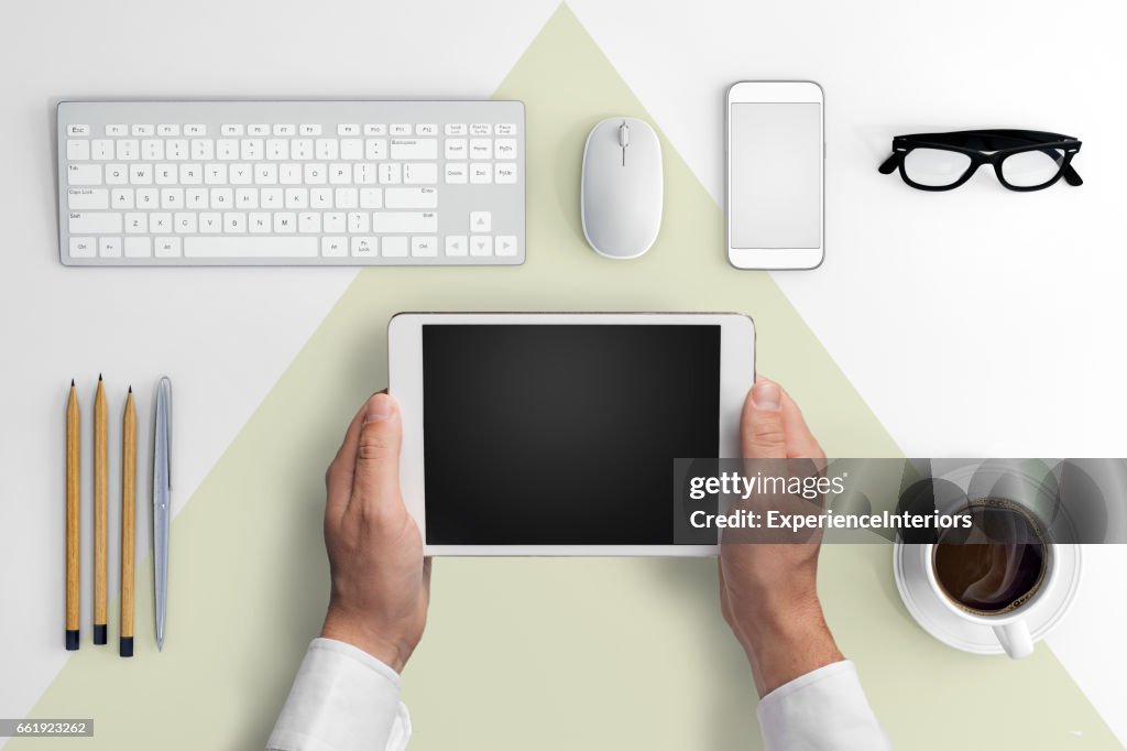 Knolling business hipster man holding tablet