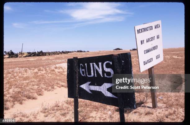 Sign points to the "boneyard", a field of abandoned Iraqi military equipment May 1, 1998 in Kuwait. Depleted uranium was used extensively by UN...