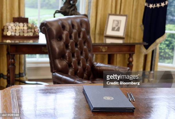 Executive orders regarding trade lay on the Resolute desk in the Oval Office of the White House in Washington, D.C., U.S., March 31, 2017. President...