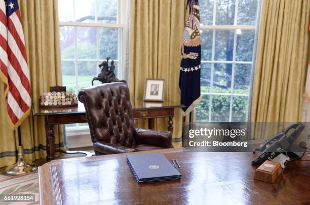 Executive orders regarding trade lay on the Resolute desk in the Oval Office of the White House in Washington, D.C., U.S., March 31, 2017. President...