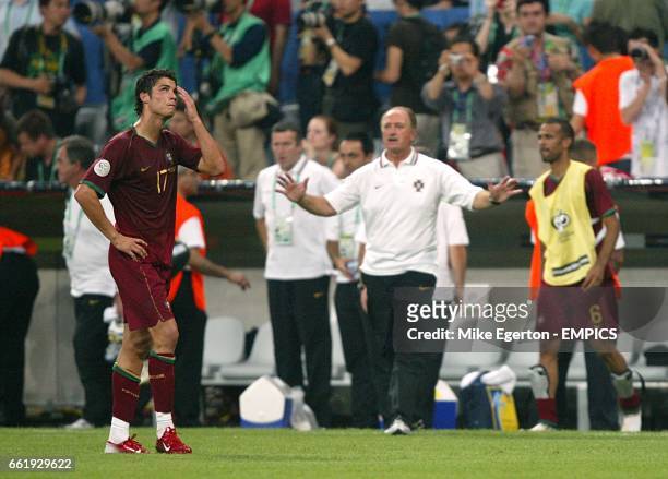 Portugal coach Luiz Felipe Scolari stands dejected with Cristiano Ronaldo