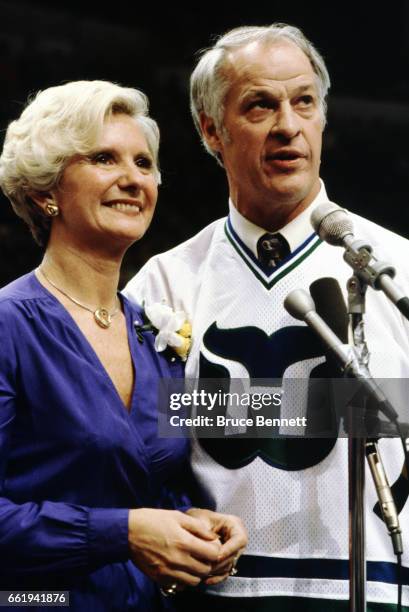 Gordie Howe, with his arm around his wife, Colleen, speaks to the fans as the Hartford Whalers retire his jersey during a pre-game ceremony prior to...