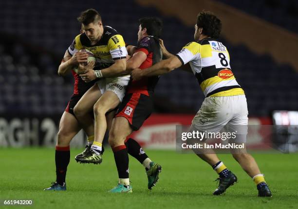 Arthur Retiere of La Rochelle is tackled by Duncan Weir of Edinburgh during The European Challenge Cup match between Edinburgh and La Rochelle at...