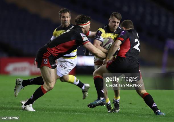 Arthur Retiere of La Rochelle is tackled by Duncan Weir of Edinburgh during The European Challenge Cup match between Edinburgh and La Rochelle at...
