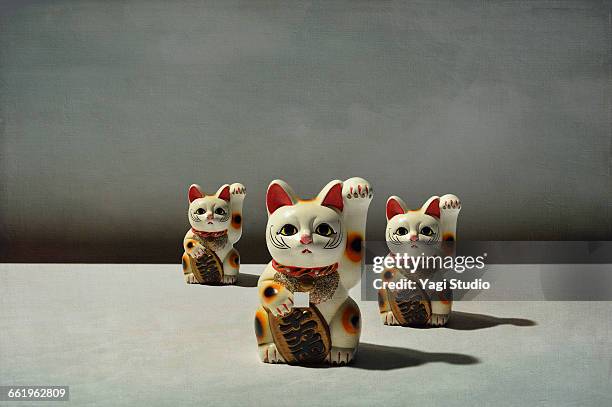 conceptual image / beckoning cat - japan culture stock pictures, royalty-free photos & images