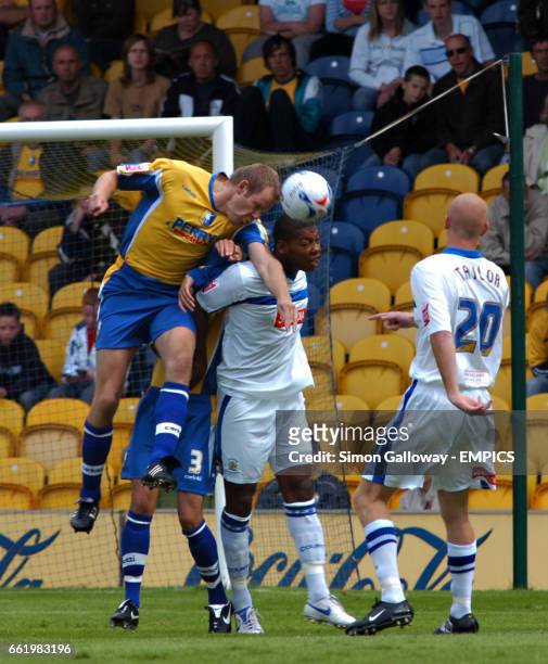 Mansfield Town's Jon Olav Hjelde and Stockport County's Tesfaye Bramble in action