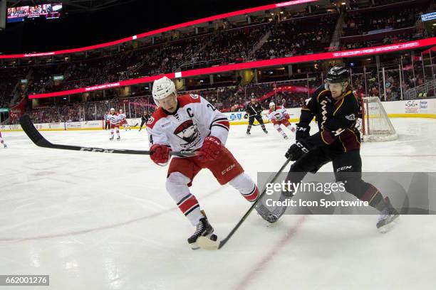 Cleveland Monsters D Dean Kukan battles Charlotte Checkers C Patrick Brown for the puck during the first period of the AHL hockey game between the...