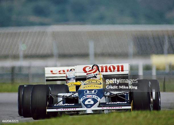 Nelson Piquet of Brazil drives the Canon Williams Honda Williams FW11 Honda V6T turbo ahead of team mate Nigel Mansell during the Formula One...