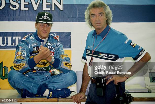 Michael Schumacher of Germany, driver of the Mild Seven Benetton Ford Benetton B195 Renault V10 talking with team director Flavio Briatore during...
