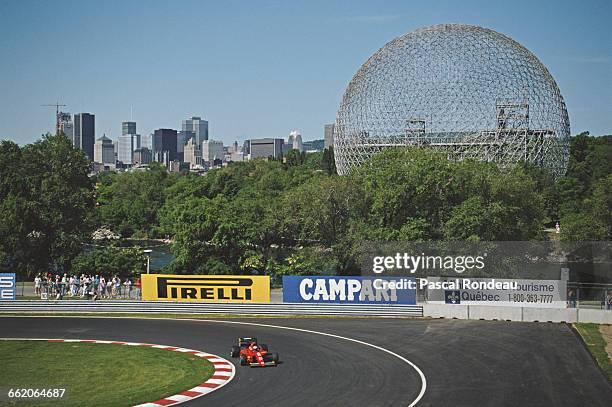 Alain Prost of France drives the Scuderia Ferrari F1-91 Ferrari V12 past the Biosphere from the 1967 International and Universal Exposition Expo 67...