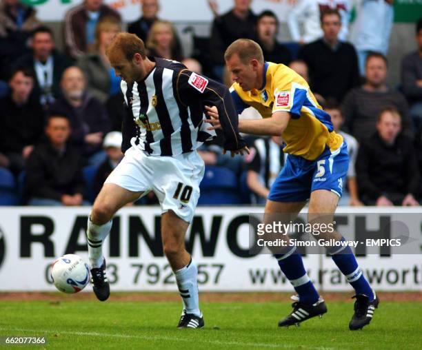 Notts County's Lawrie Dudfield and Mansfield Town's Jon Olav Hjelde in action